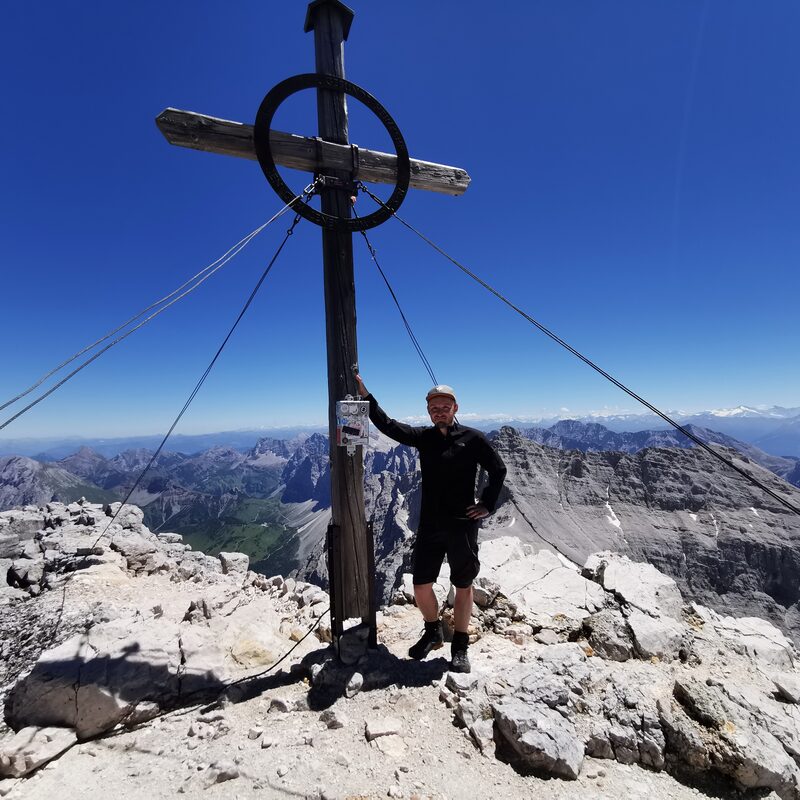Matthias at the summit cross of the Birkkarspitze in the Karwendel mountains